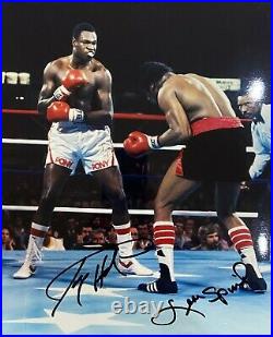 An original signed photograph by Larry Holmes/Leon Spinks (with COA)