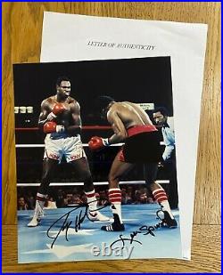 An original signed photograph by Larry Holmes/Leon Spinks (with COA)